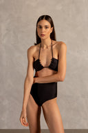 Model wearing the Golden Age Solid High-Waisted Bikini Close showcasing its ball-shaped applications with Black print on 85% polyamide 15% spandex fabric, styled for a beachwear look.