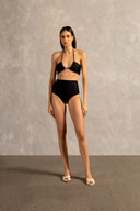 Model wearing the Golden Age Solid High-Waisted Bikini Front showcasing its ball-shaped applications with Black print on 85% polyamide 15% spandex fabric, styled for a beachwear look.
