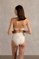 Model wearing the Golden Age Solid High-Waisted Bikini Back   showcasing its ball-shaped applications with Off White print on 85% polyamide 15% spandex fabric, styled for a beachwear look.