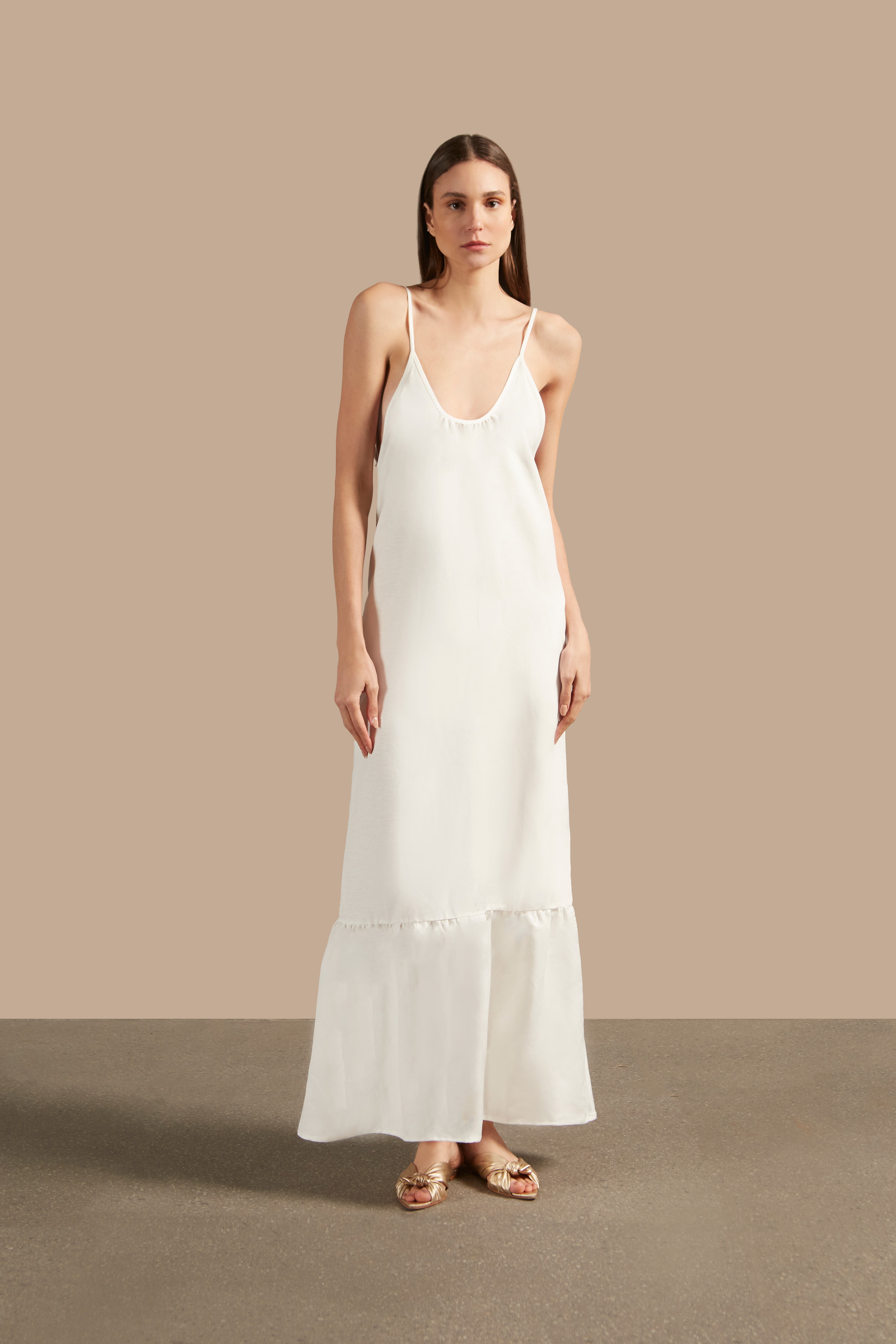 Front view of the Golden Age Solid Straps Long Dress in off-white, highlighting its fluid silhouette and elegant trim details.