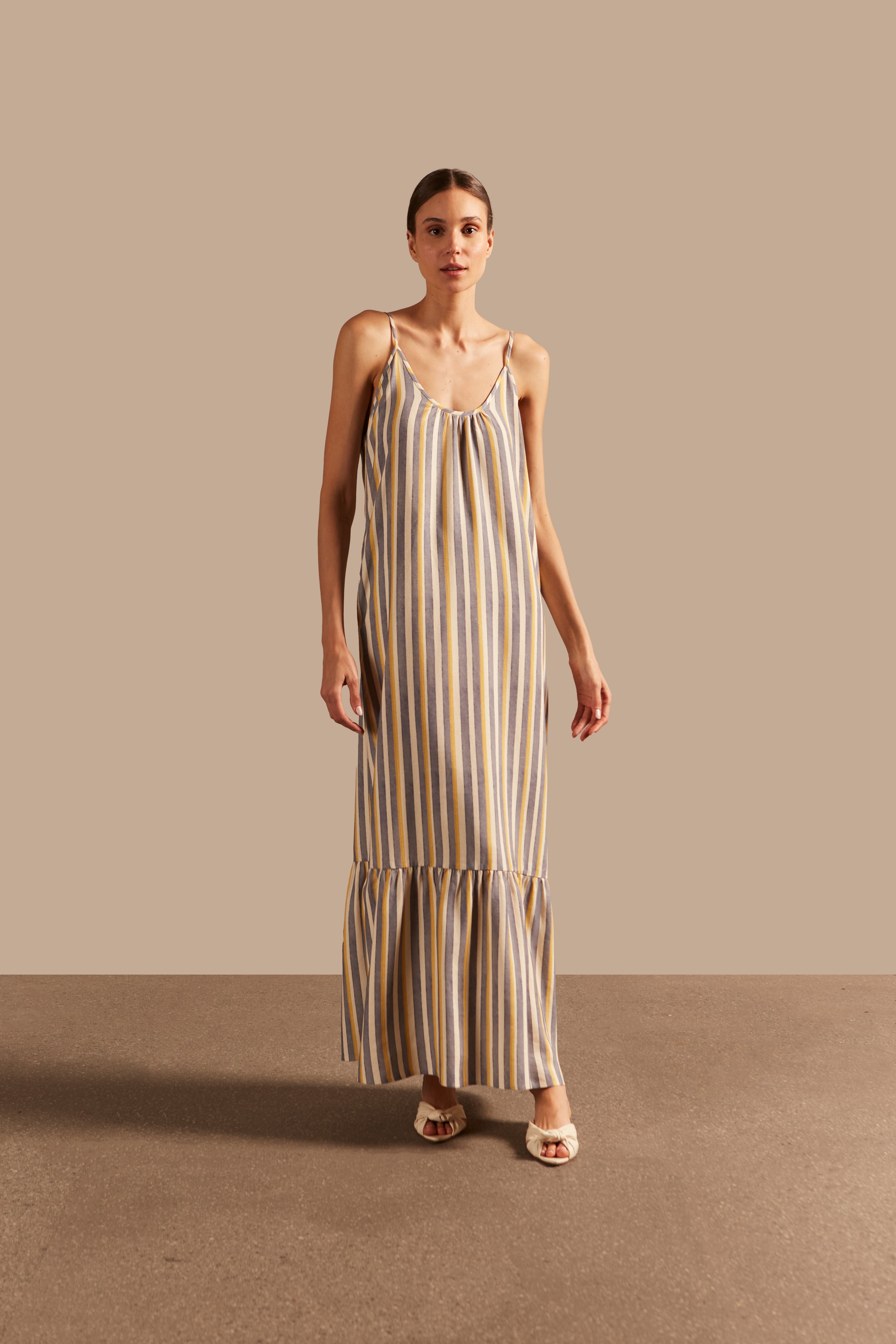 Full front view of the Golden Age Straps Linen Long Dress featuring a striped design in grey, off-white, and yellow, with thin straps and a flowing silhouette.