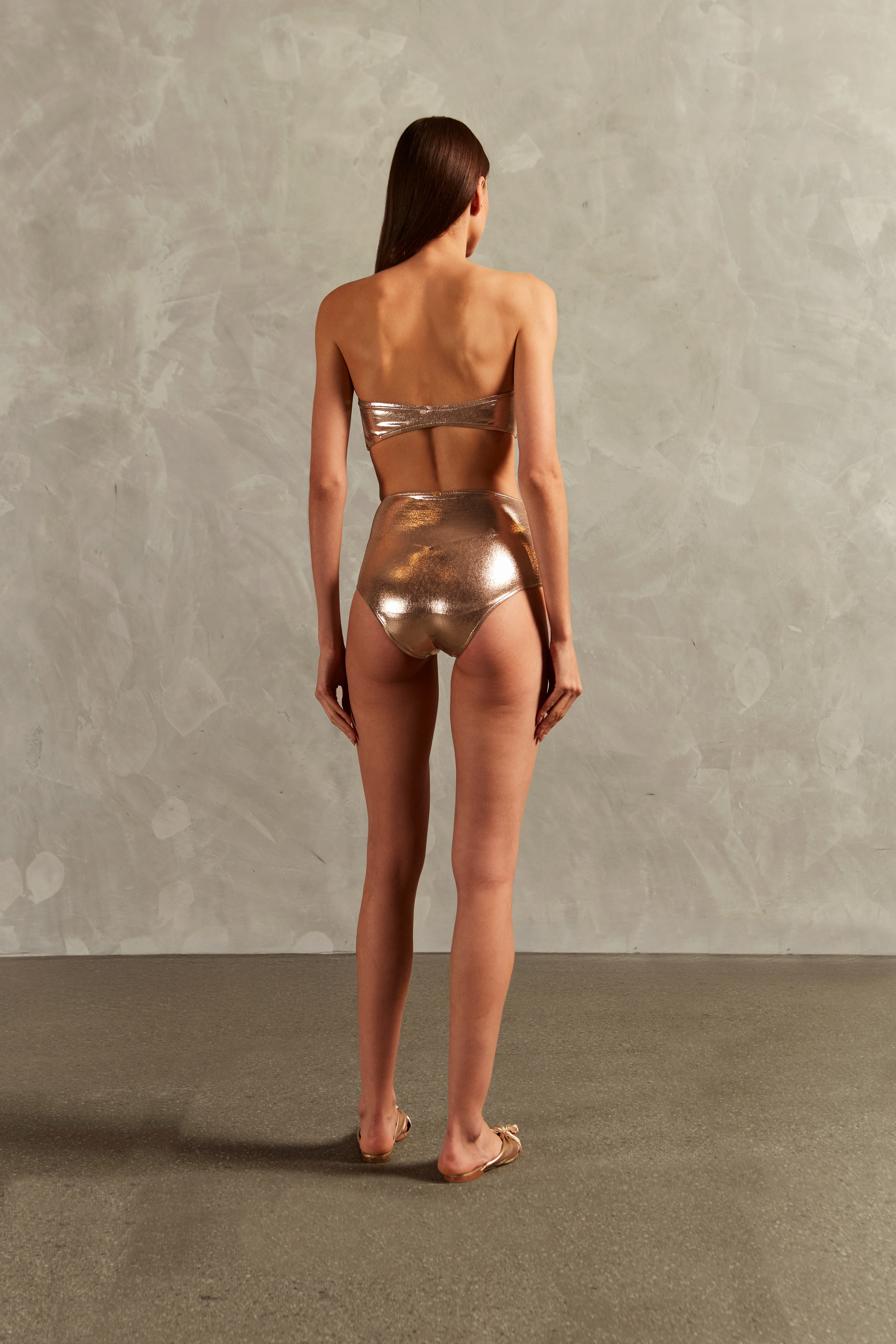 Model wearing the Golden High-Waisted Bandeau Bikini Back showcasing its Light Gold color on 92% polyester 8% elastane fabric.