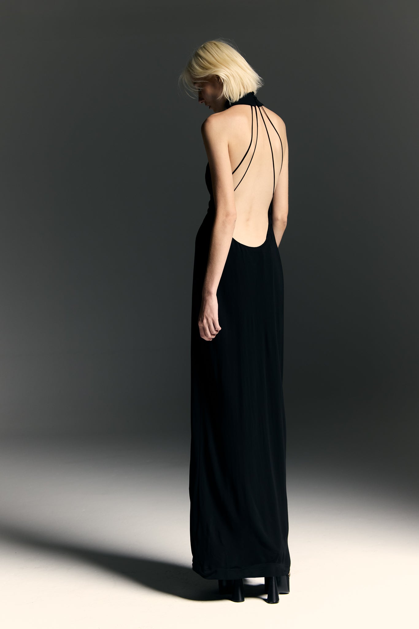 Model wearing the Halterneck Maxi Dress black back from the Adriana Degreas and Sabine Getty collab with 96% Viscose 4% Elastane styled for a dinner look. 