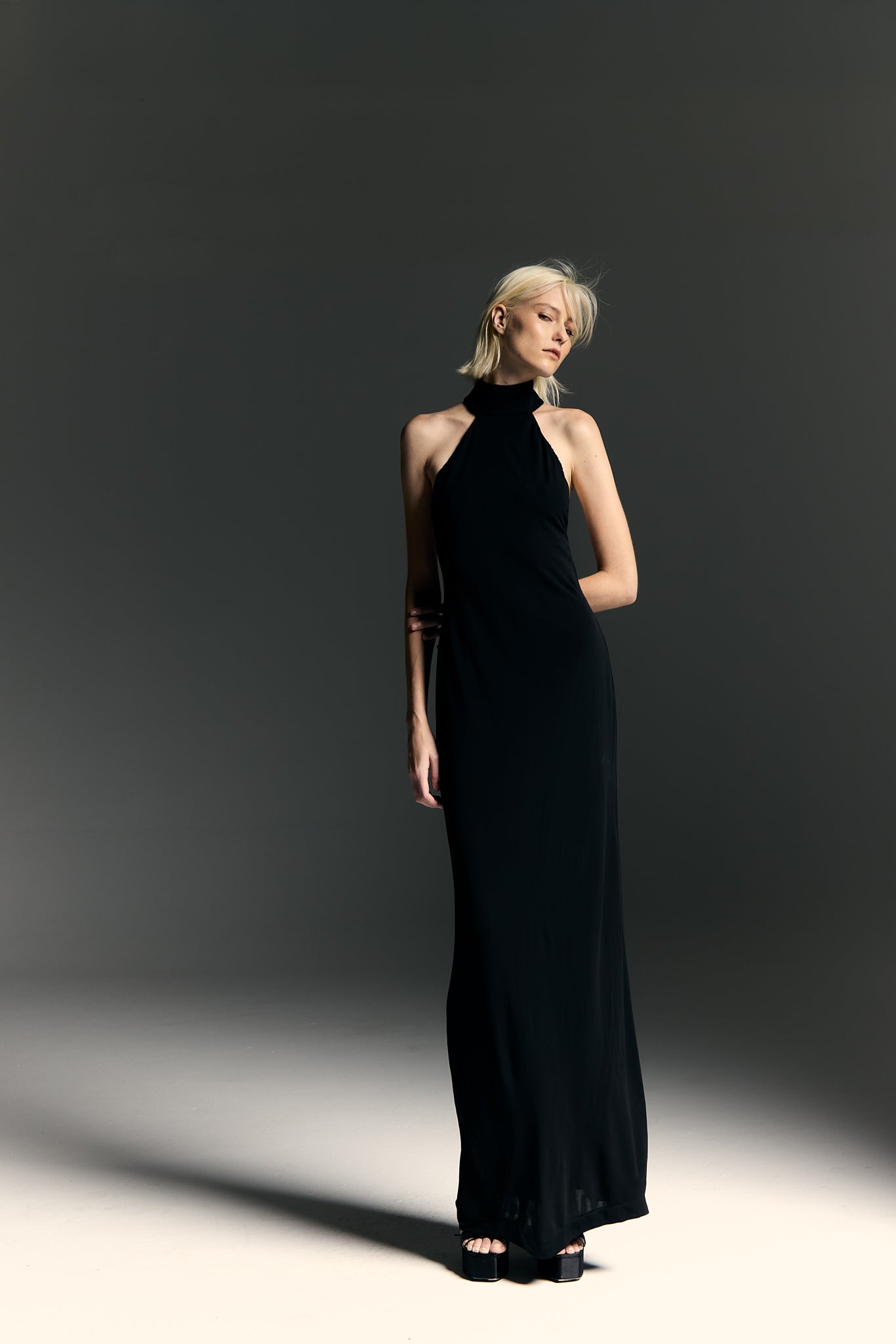 Model wearing the Halterneck Maxi Dress black front from the Adriana Degreas and Sabine Getty collab with 96% Viscose 4% Elastane styled for a dinner look. 