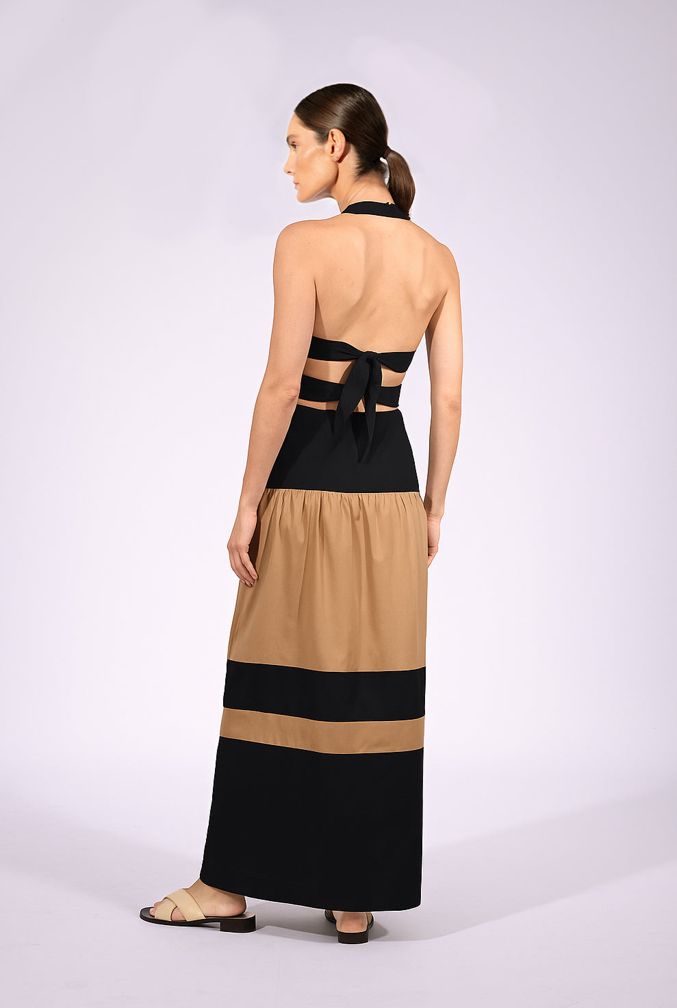 Model wearing the Halterneck Maxi Dress back made from 100% viscose, styled for a resort look.