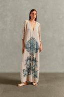 Model wearing the Hera Buttoned Long Robe pose showcasing its vintage references with Off White print on 100% Viscose fabric, styled for a resort look. 
