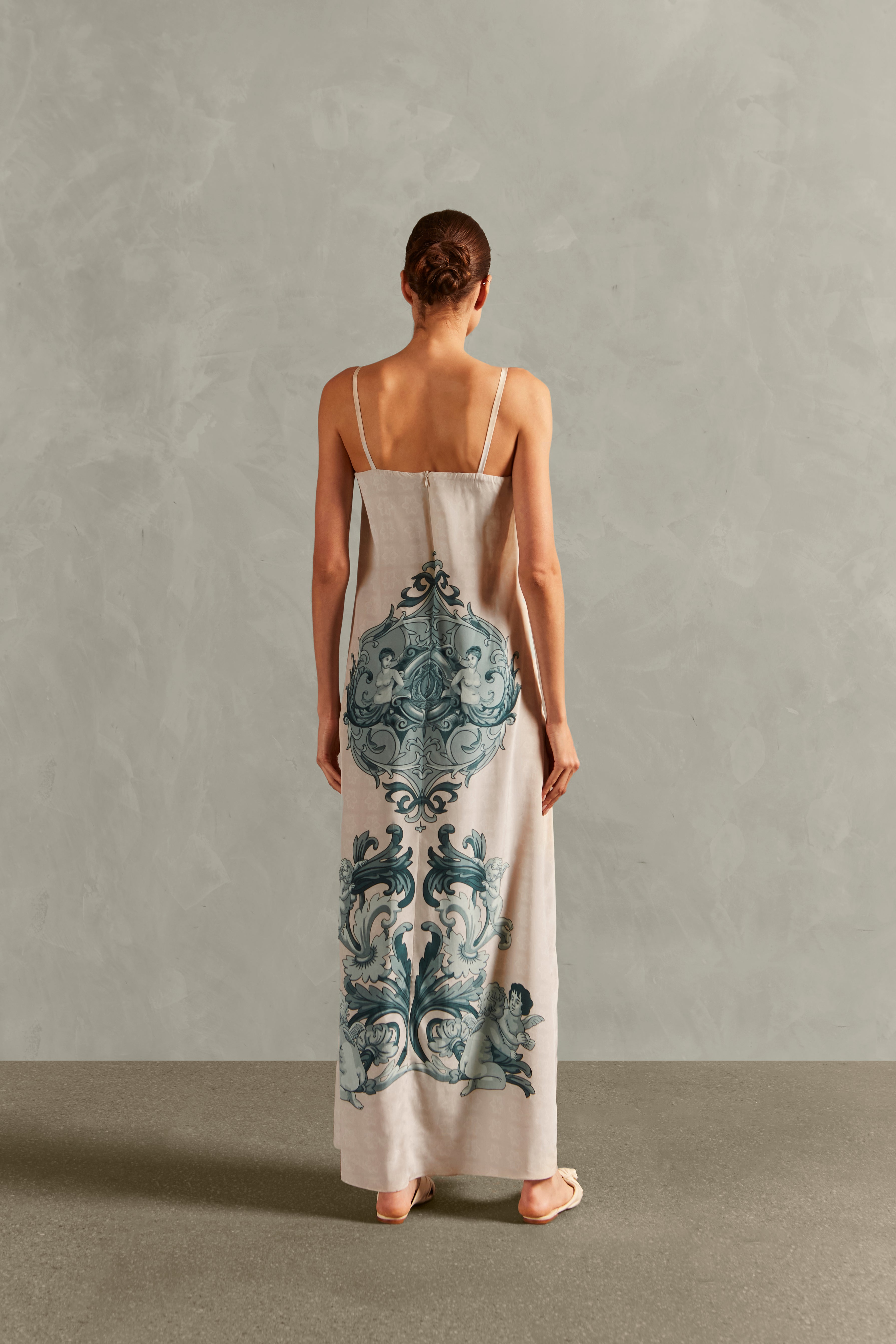 Model wearing the Hera Deep-V Long Dress Back showcasing its Off White color on 100% Silk fabric.  