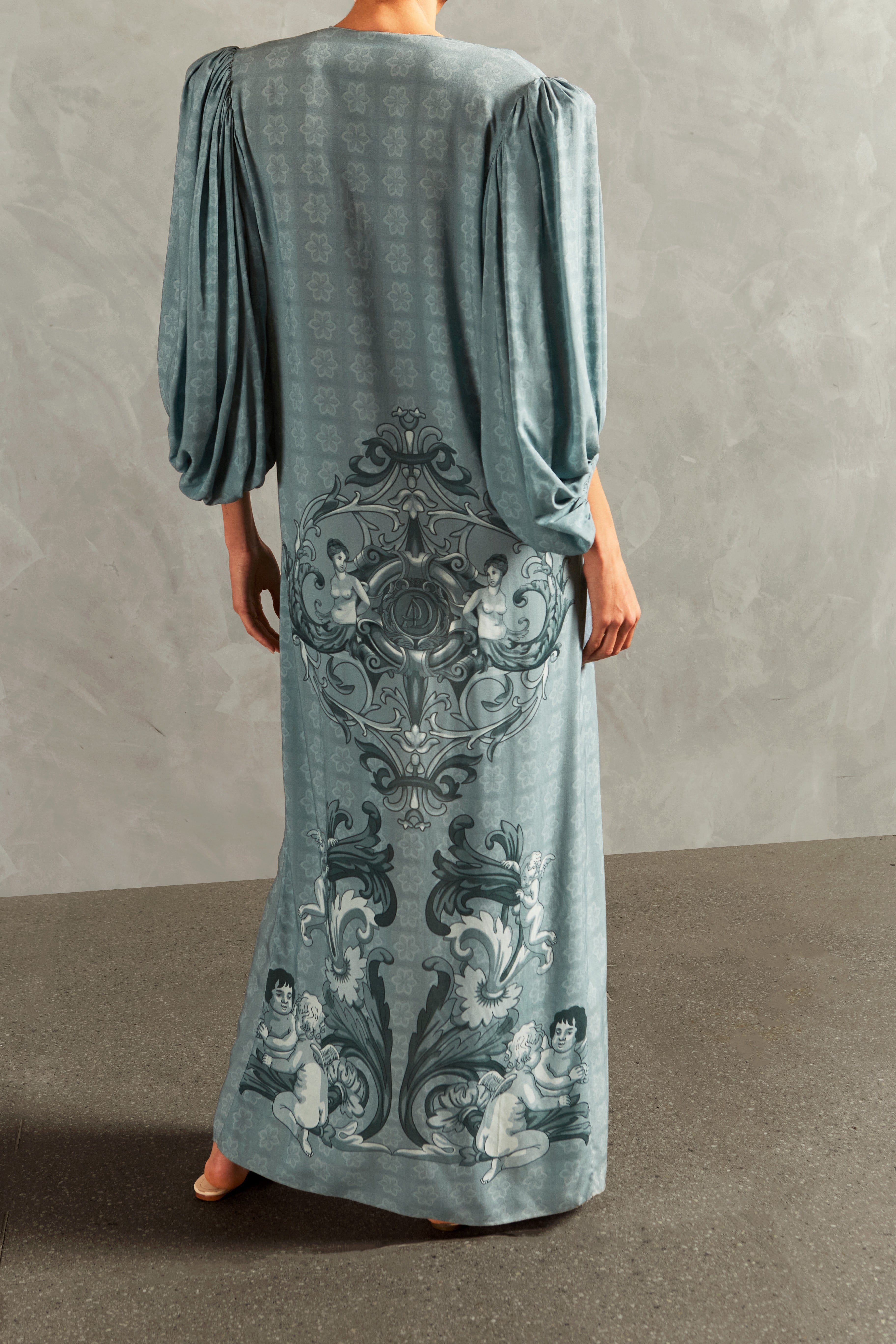 Model wearing the Hera Long Robe Back showcasing its BLUE color on 100% Viscose fabric, styled for a resort look.