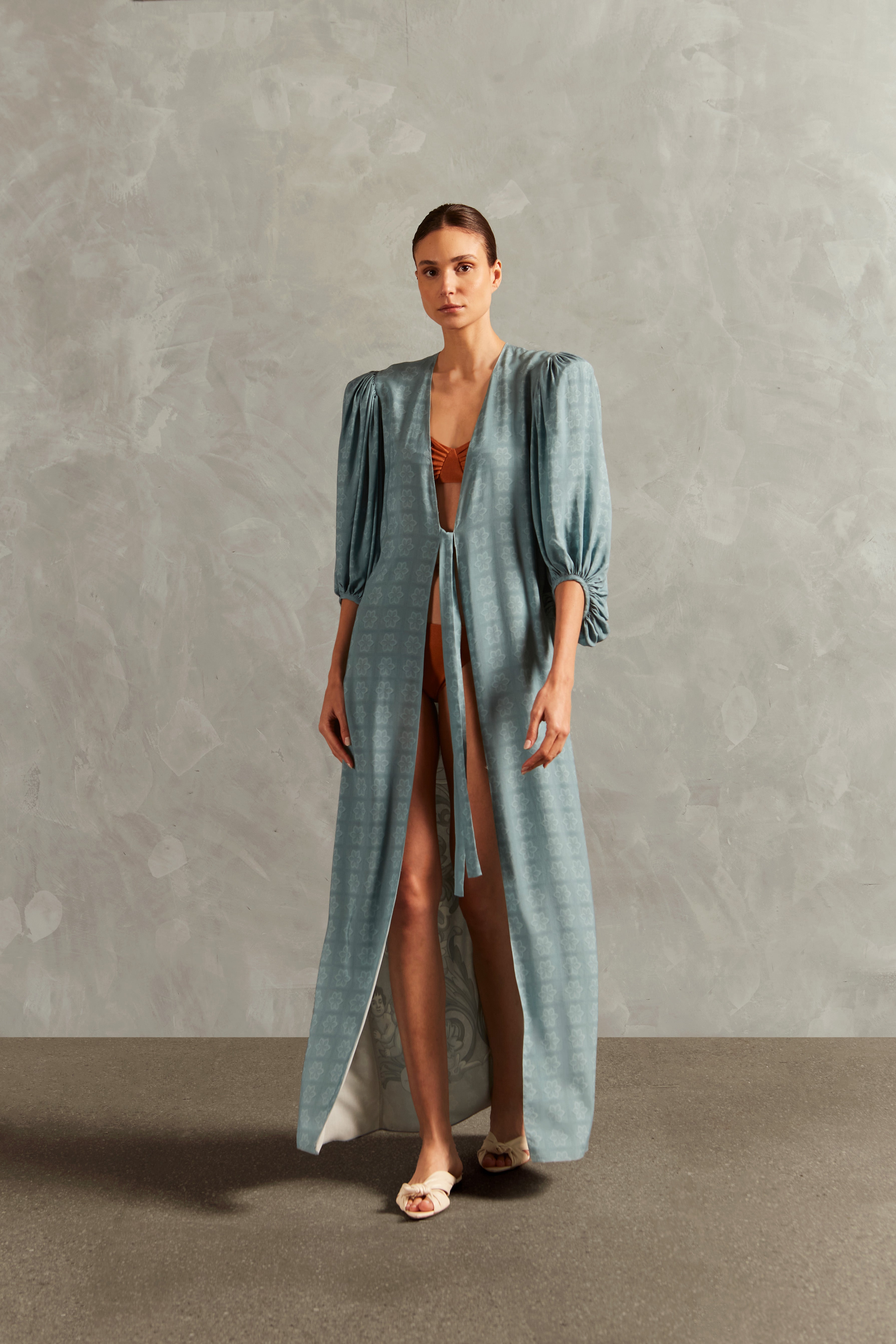 Model wearing the Hera Long Robe Front showcasing its BLUE color on 100% Viscose fabric, styled for a resort look.