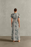 Model wearing the Hera Puff-Sleeved Long Dress Back showcasing its BLUE color on 100% Viscose fabric, styled for a resort look.  