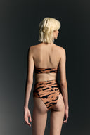 Model wearing the High-Leg Strapless Bikini back from the Adriana Degreas and Sabine Getty collab with 75% Polyamide 25% Elastane styled for a beachwear look. 