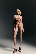 Model wearing the High-Leg Strapless Swimsuit With Removable Choker front from the Adriana Degreas and Sabine Getty collab with 75% Polyamide 25% Elastane styled for a drinks by the pool look. 