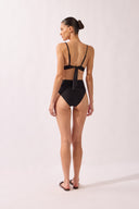 Model wearing the High-Leg Belted Bikini back color black, made from 85% polyamide 15% elastane, styled for a beachwear look