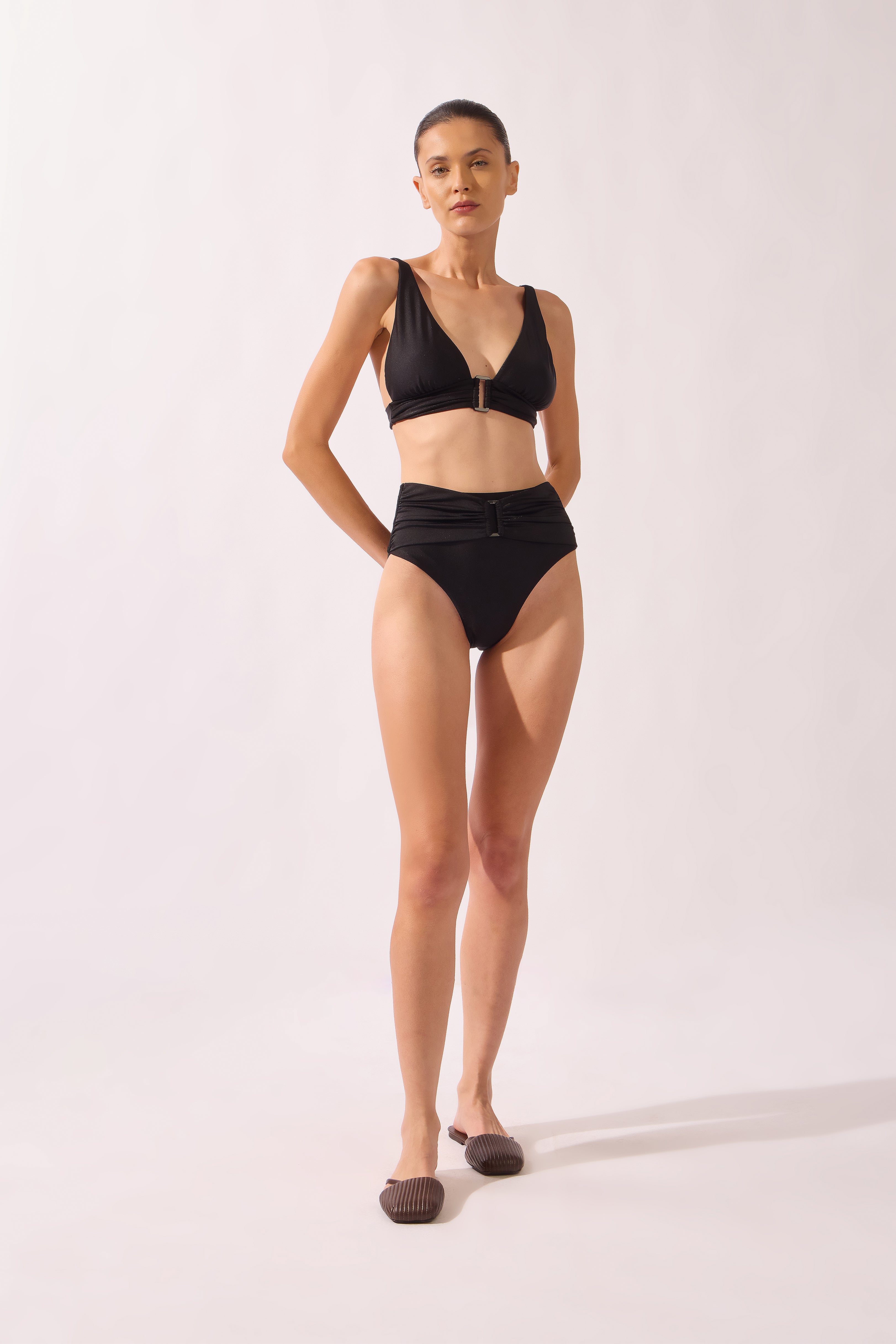 Model wearing the High-Leg Belted Bikini front color black, made from 85% polyamide 15% elastane, styled for a beachwear look