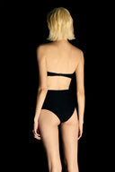 Model wearing the High-Waisted Cut-Out Bikini back detail from the Adriana Degreas and Sabine Getty collab with 75% Polyamide 25% Elastane styled for a beachwear look.