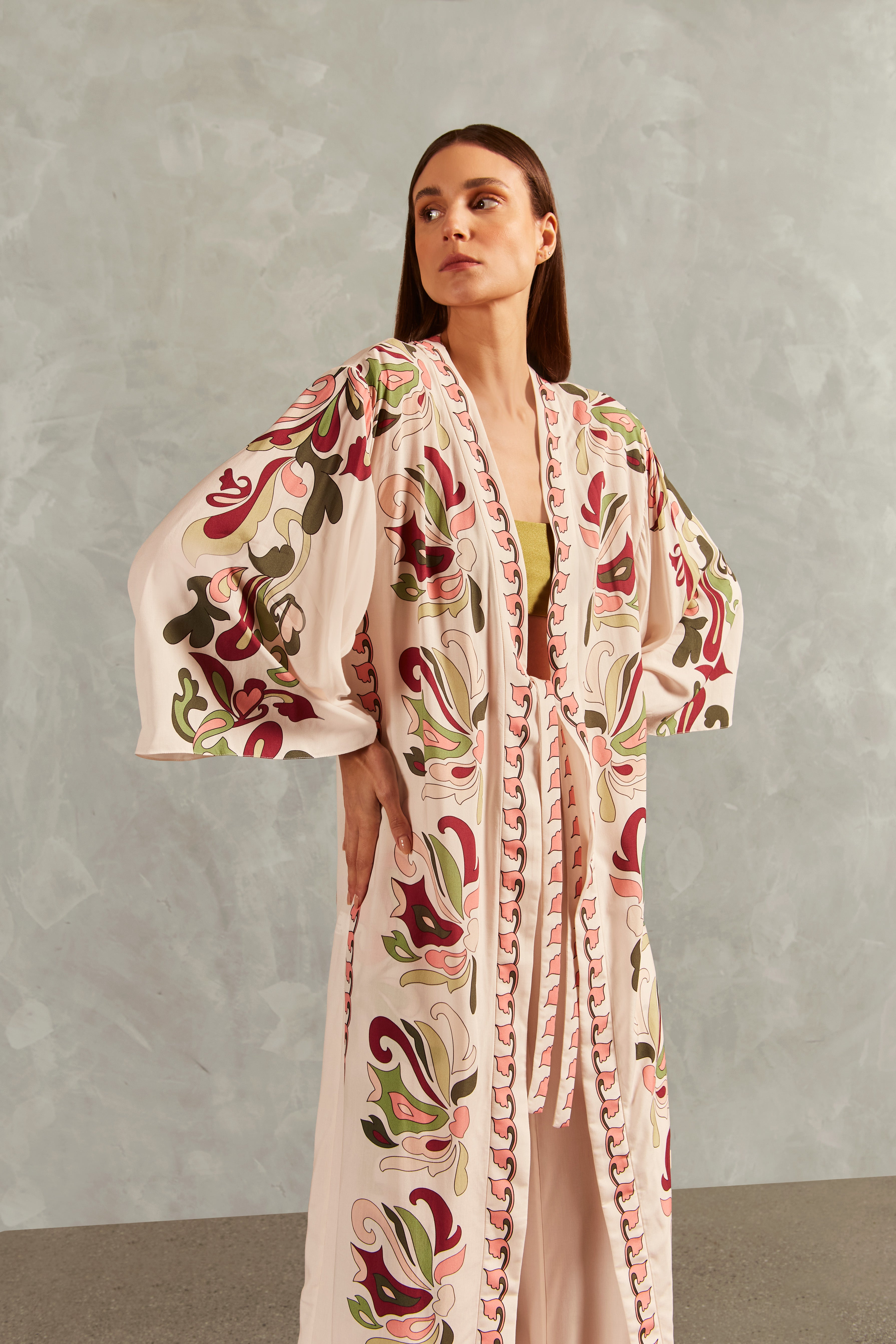 Model wearing the Inamorata Long Robe Detail showcasing its Off White color on 100% Viscose fabric, styled for an post-beach look.