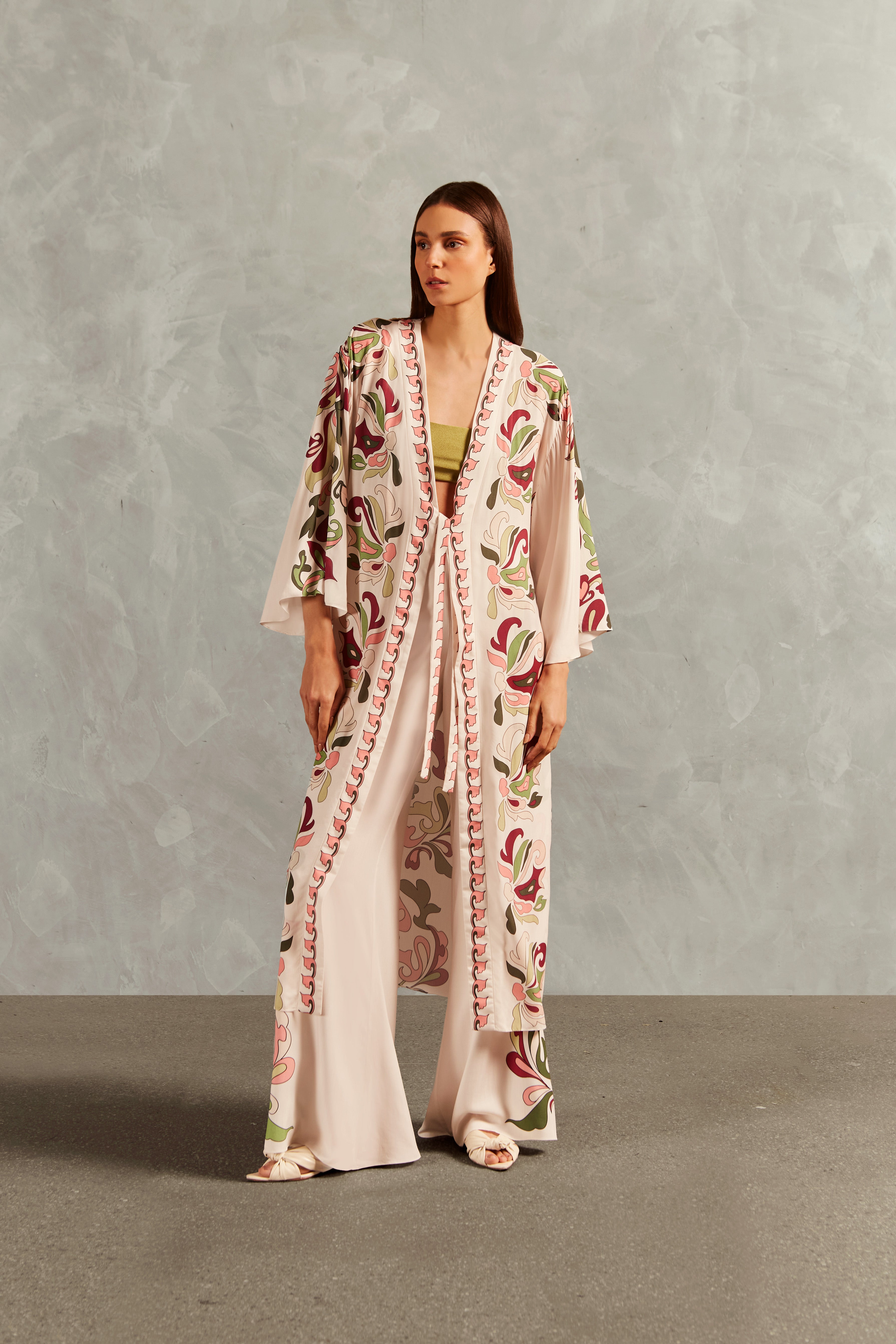 Model wearing the Inamorata Long Robe Front showcasing its Off White color on 100% Viscose fabric, styled for an post-beach look.