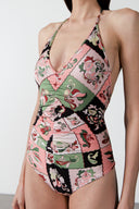 Model wearing the Inamorata Ruched Swimsuit detail color pink with 85% Polyamide 15% Elastane styled for a beachwear look  