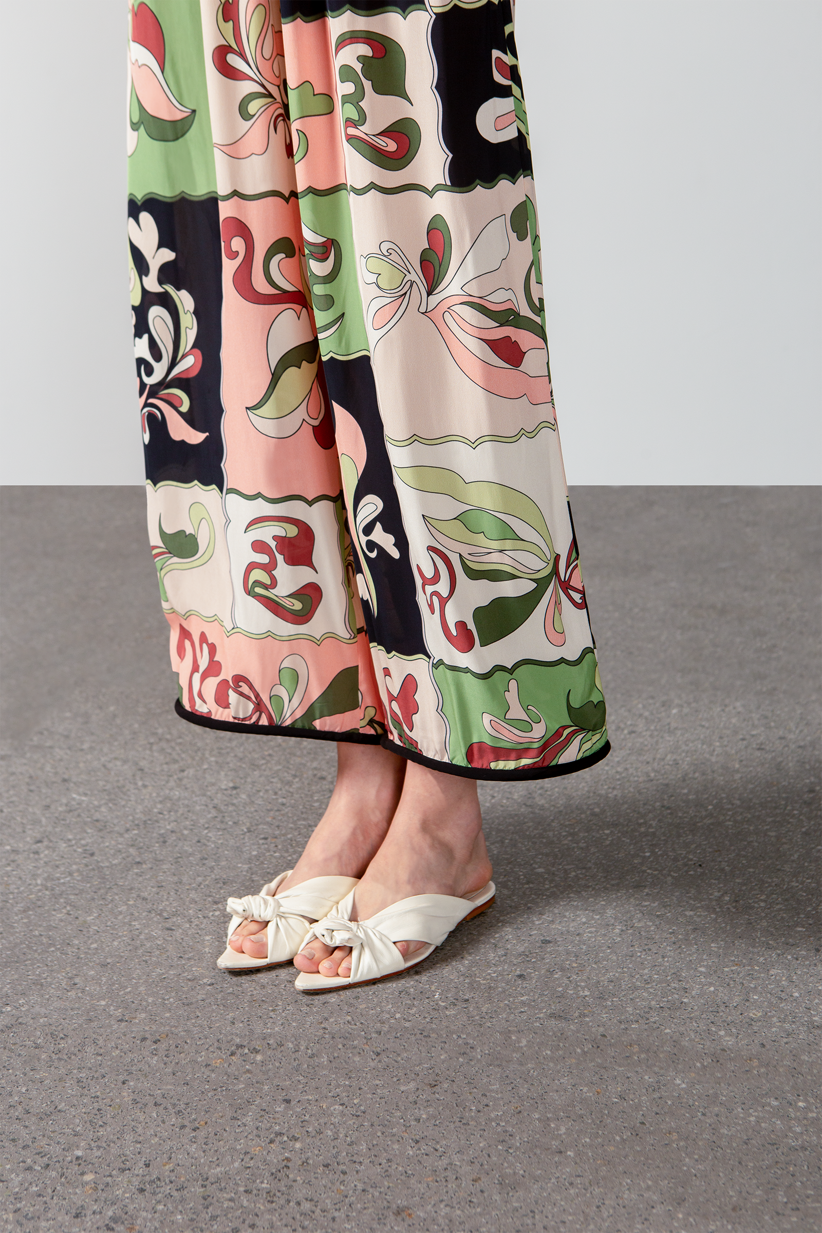 Model wearing the Inamorata Straight-Leg Pants detail color green made with 100% viscose, styled for resortwear look 