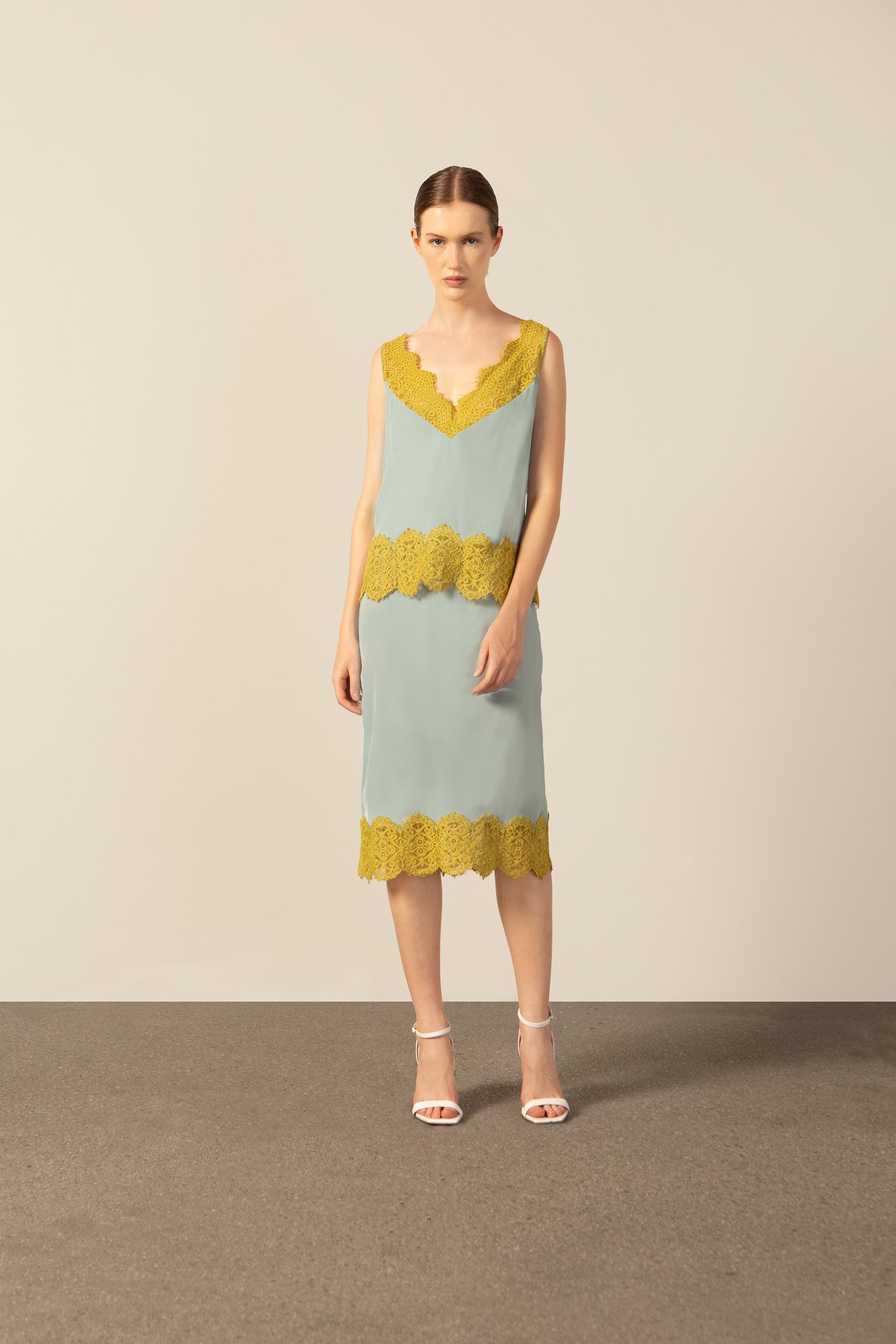 Model wearing La Sirenuse Lace Midi Skirt front color blue, made from 100% viscose, styled for a resort look