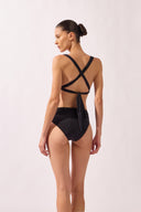 Model wearing the Lace-Up Back Bikini back color black, made from 85% polyamide 15% elastane, styled for a beachwear look
