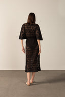 Model wearing the  Lace V-Neck Lace Long Dress Back showcasing its Black color on 80% Polyester 20% Cotton fabric.   