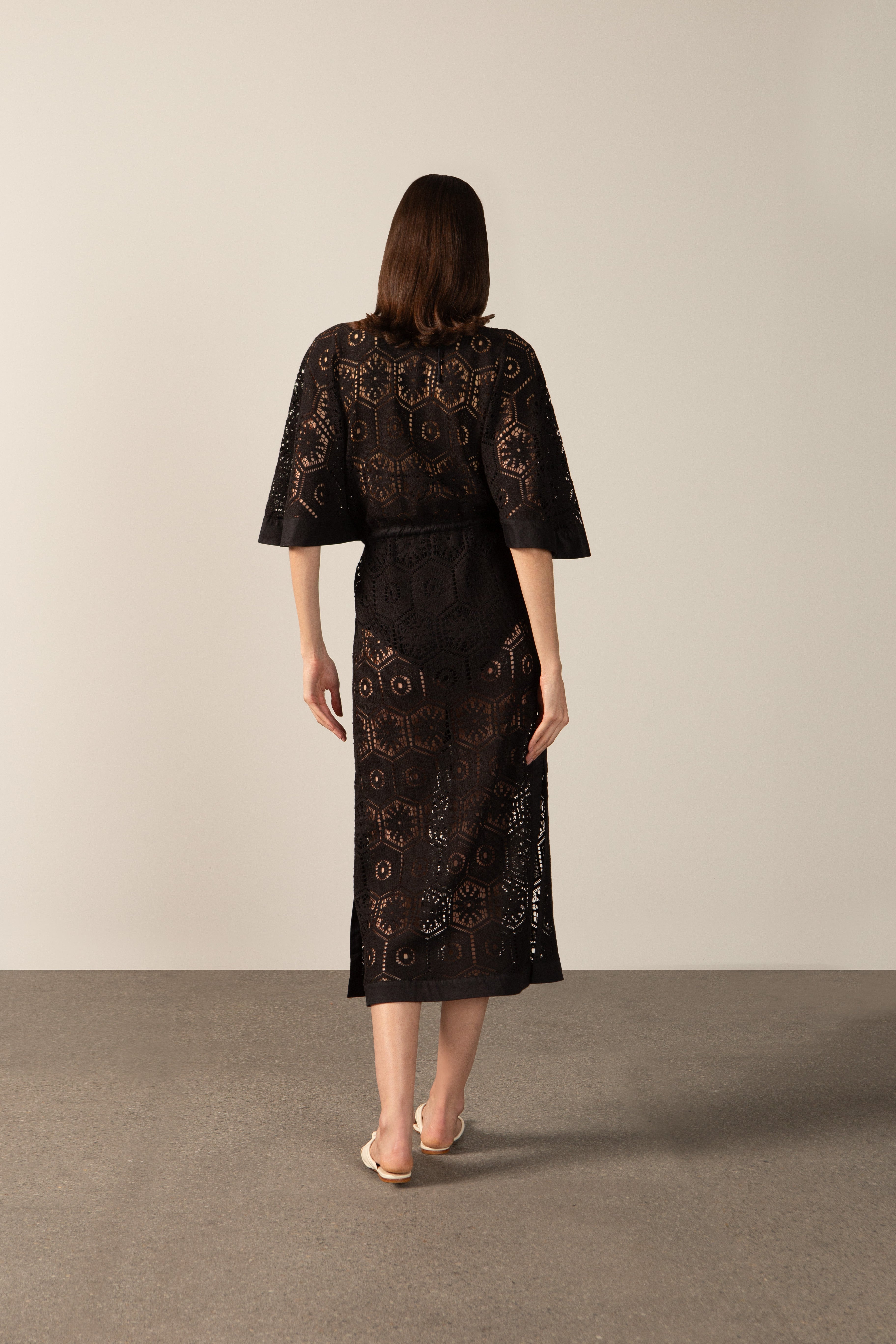 Model wearing the  Lace V-Neck Lace Long Dress Back showcasing its Black color on 80% Polyester 20% Cotton fabric.   