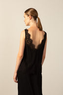 Model wearing the Lace Short Dress black back detail from the HS25 with 100% viscose styled for a dinner and drinks look.  