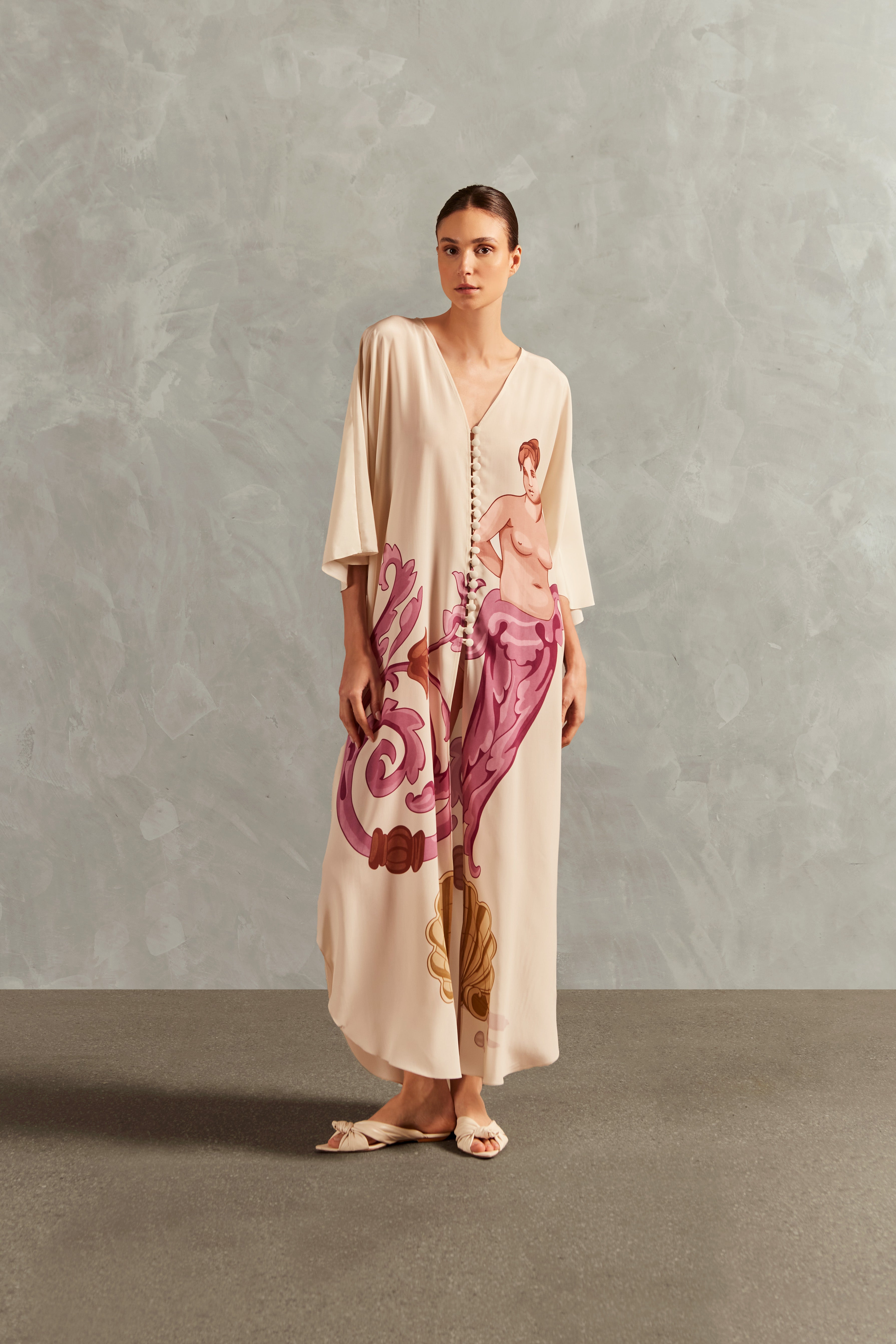 Model wearing the Le Sirenuse Buttoned Midi Kaftan Front showcasing its Lilac color on 100% Silk fabric, styled for an afternoon look.