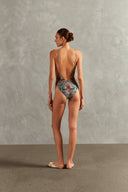 Model wearing the Le Sirenuse Side-Boob Swimsuit Back showcasing its Turquoise color on 85% Polyamide 15% Elastane fabric, styled for a beachwear look.