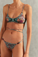 Model wearing the Le Sirenuse Wraparound Ties Bikini Detail showcasing its Turquoise color on 85% polyamide 15% elastane fabric.