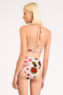 Model wearing the Lina High-Leg Bikini Set color unique, made from 85% polyamide 15% elastane, styled for beachwear look
