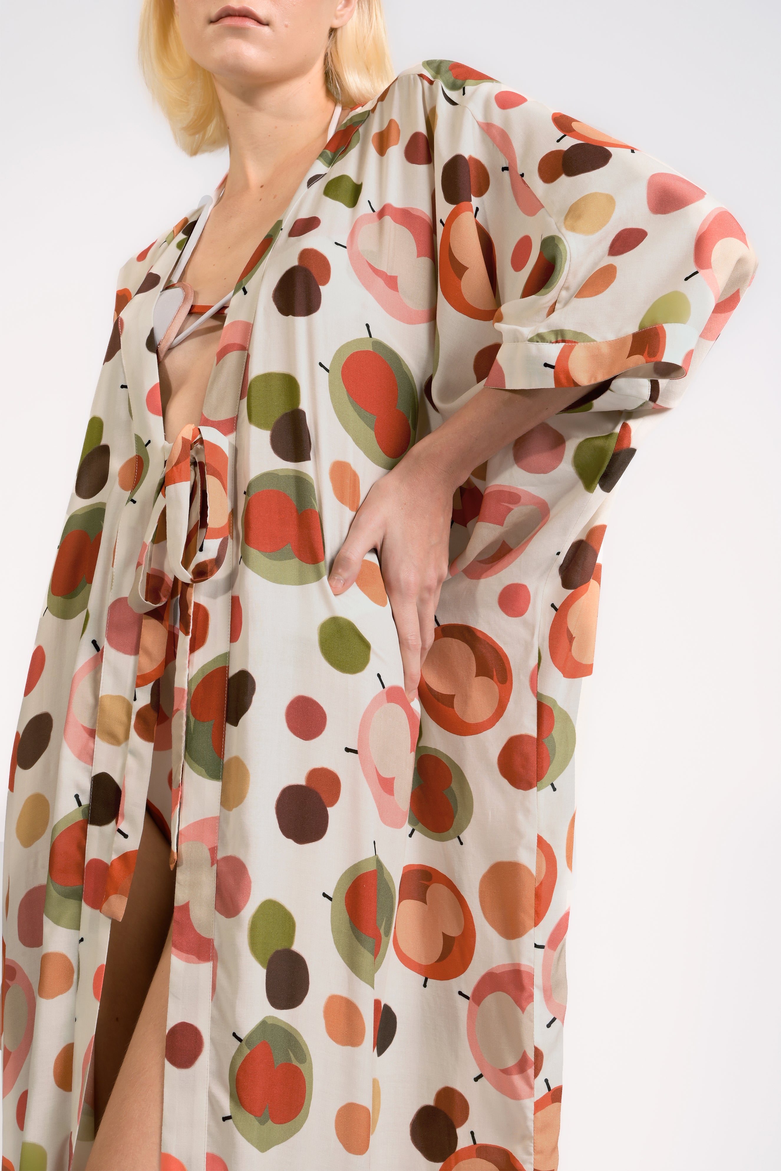 Model wearing the Lina Maxi Robe detail color unique, made from 100% viscose, styled for beachwear look 