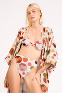 Model wearing the Lina Maxi Robe detail pieces color unique, made from 100% viscose, styled for beachwear look 