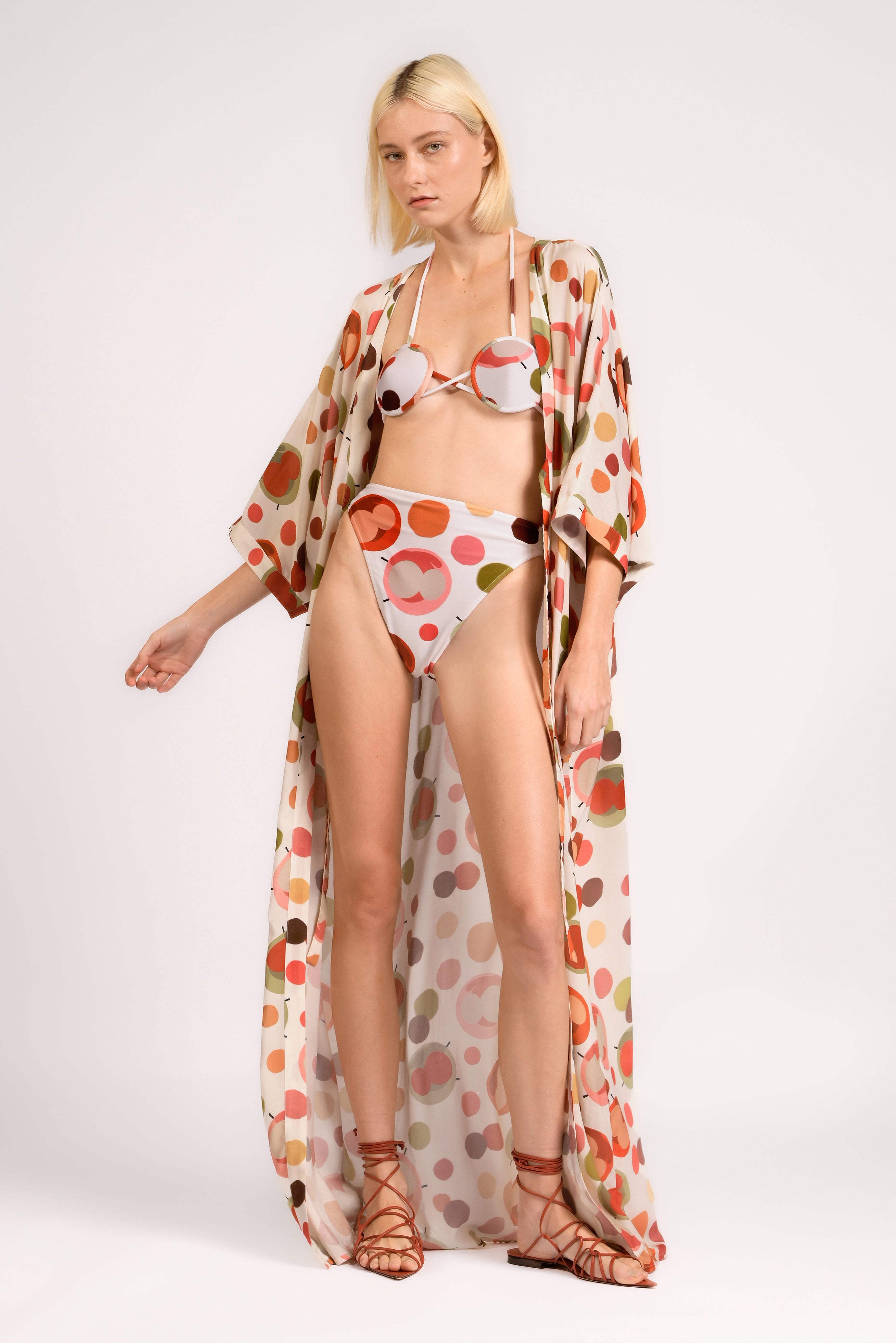 Model wearing the Lina Maxi Robe look color unique, made from 100% viscose, styled for beachwear look 