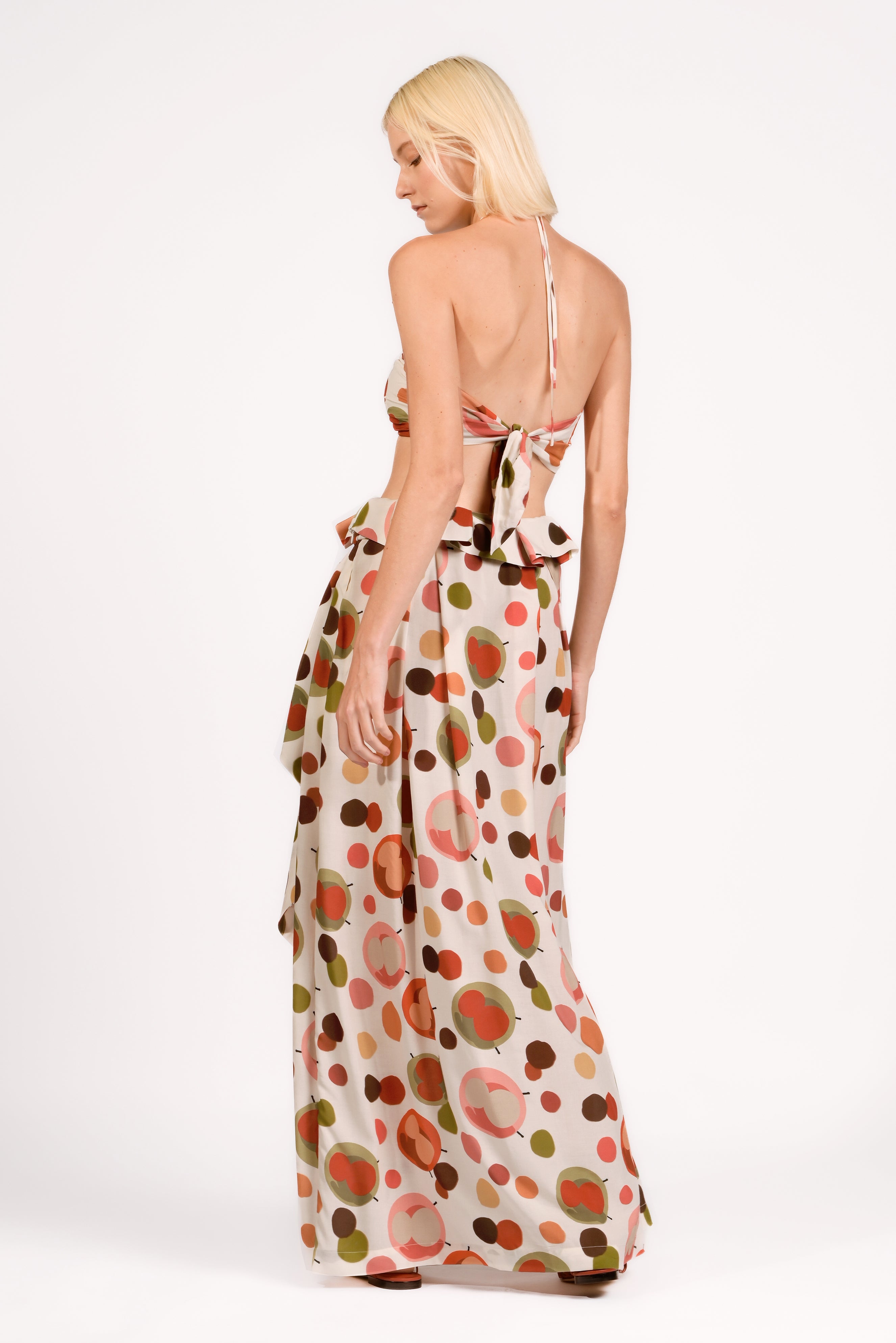 Model wearing the Lina Maxi Skirt Back color unique, made from 100% viscose, styled for resort look 