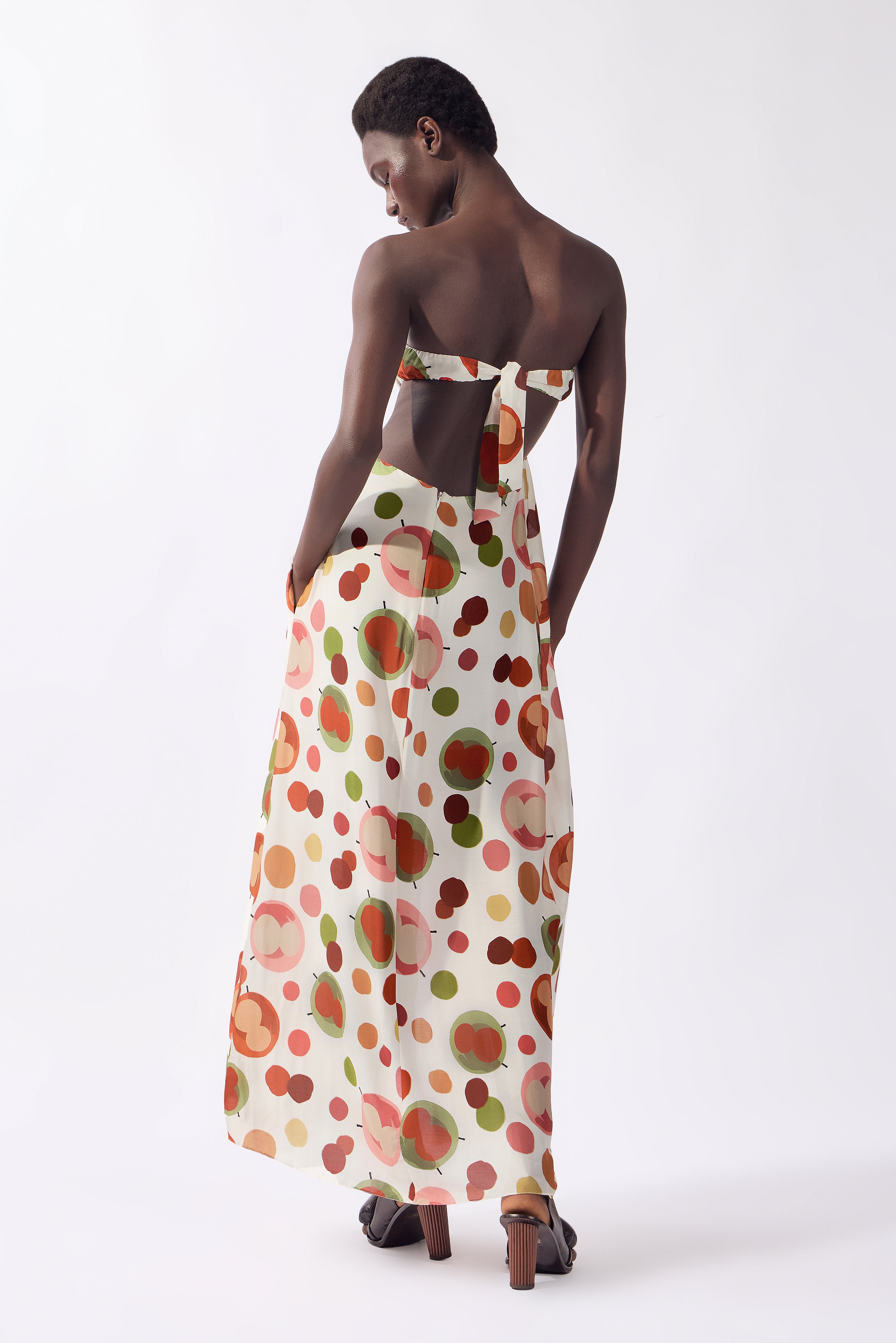 Model wearing the Lina Off-The-Shoulder Maxi Dress back color unique, made from 80% viscose 20% silk, styled for a dinner look 