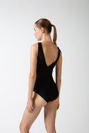 Model wearing the Solid V-Neck Swimsuit back, made from 85% polyamide 15% elastane, styled for a beachwear look 