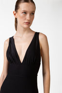 Model wearing the Solid V-Neck Swimsuit detail, made from 85% polyamide 15% elastane, styled for a beachwear look 