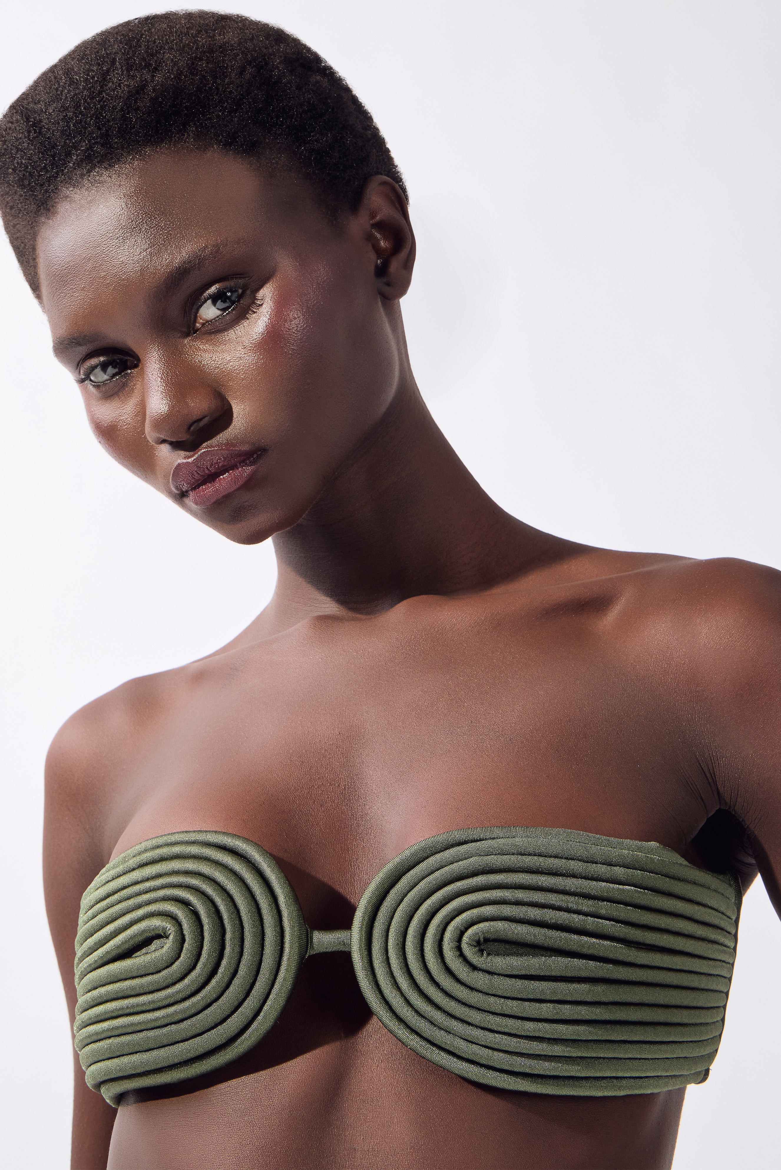 Model wearing the Matelasse Bandeau Bikini Set detail color olive, made from 85% polyester 15% elastane, styled for a beachwear look