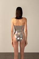 Model wearing the  Metallic Cut-Out Halterneck Swimsuit silver back from the HS25 with 92% POLYESTER 8% ELASTANE styled for a pool party look.  