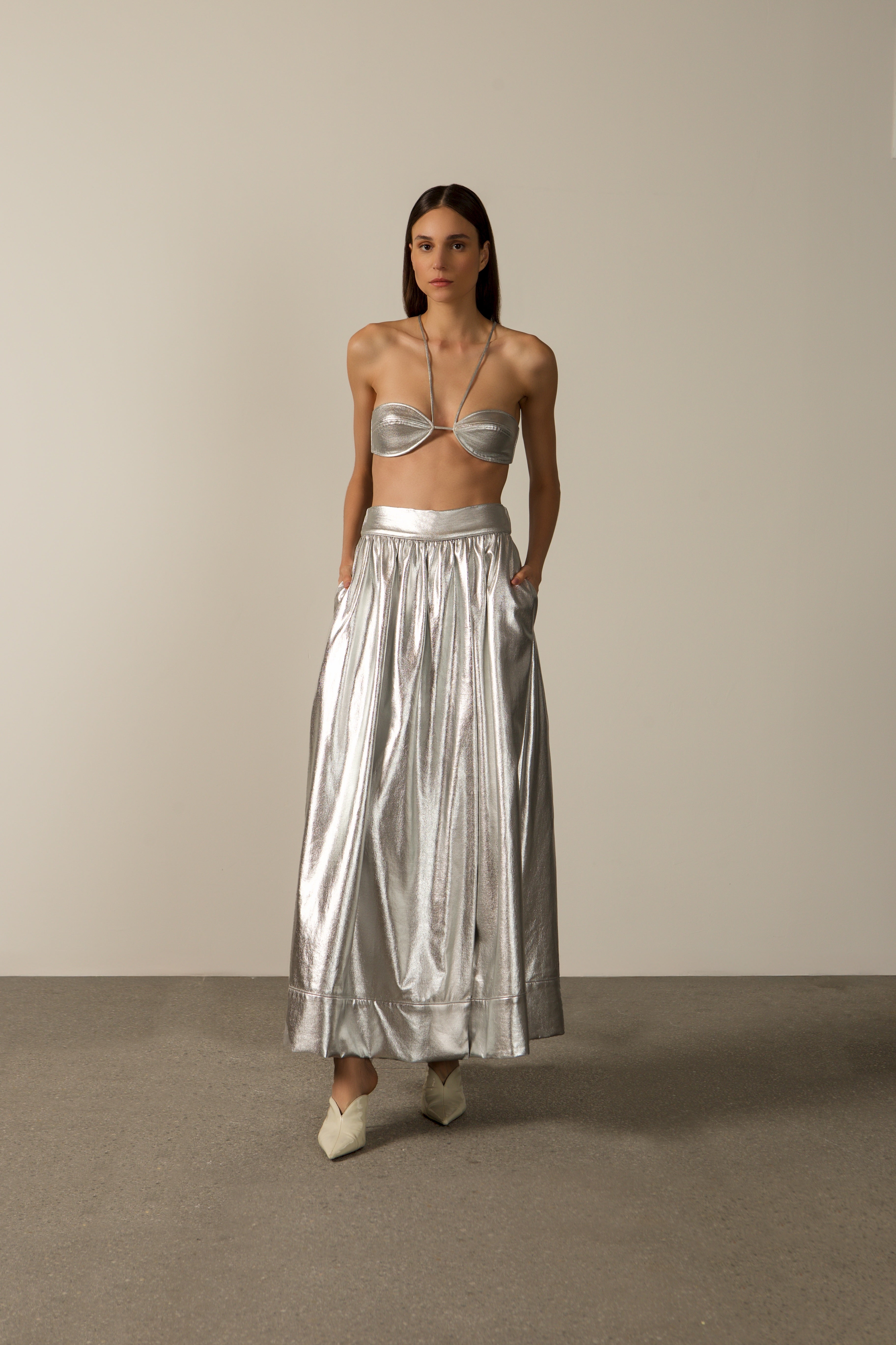 Model wearing the Metallic Top and Skirt Set in silver styled for a night drink