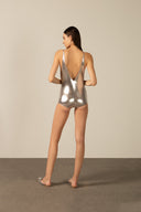 Model wearing the Metallic V-Neck Swimsuit silver back from the HS25 with 92% POLYESTER 8% ELASTANE styled for a pool party look.   