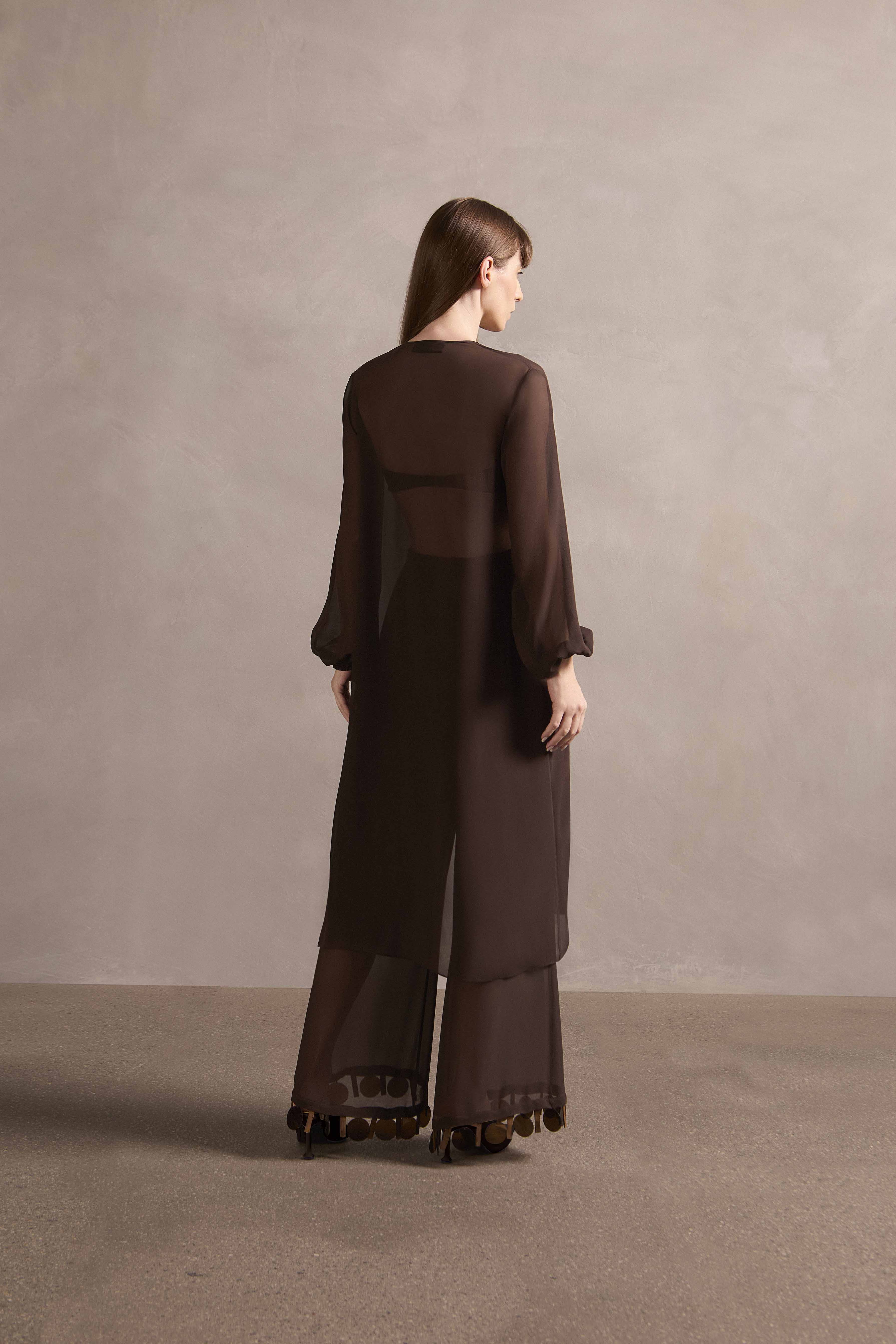 Model wearing the Mobile Midi Robe With Pants Back showcasing its contemporary elements with coffee print on 100% silk fabric used with pants, styled for a night look.