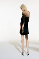 Model wearing the Open Sided Mini Dress black back from the Adriana Degreas and Sabine Getty collab with 96% Viscose 4% Elastane styled for a casual look. 