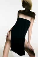 Model wearing the Open Sided Mini Dress black front from the Adriana Degreas and Sabine Getty collab with 96% Viscose 4% Elastane styled for a casual look. 