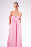 Model wearing the Opulence Straps Maxi Dress front color light pink made with 97% Cotton 3% Elastane,  styled for a lunch look 