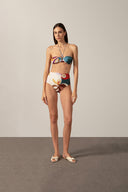 Model wearing the Organic Floral High-Waisted Bikini with unique color styled for a beach look