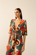 Model wearing the Organic Floral Puff-Sleeved Blouse with unique color styled for a beach look