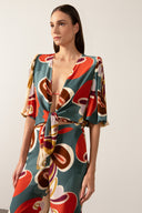 Model wearing the Organic Floral Puff-Sleeved Blouse front with unique color styled for a beach look